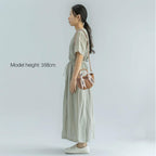 Eiyye off-white woven straw beach bag with shoulder straps, perfect for summer outings and stylish beach trips.