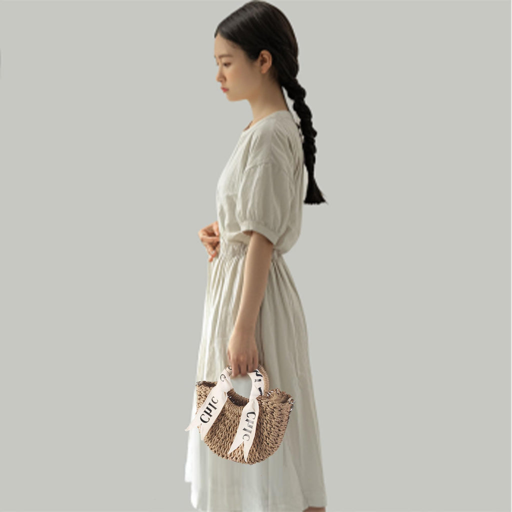 Eiyye off white woven straw beach handbag with shoulder straps, perfect for summer outings and stylish beach days.