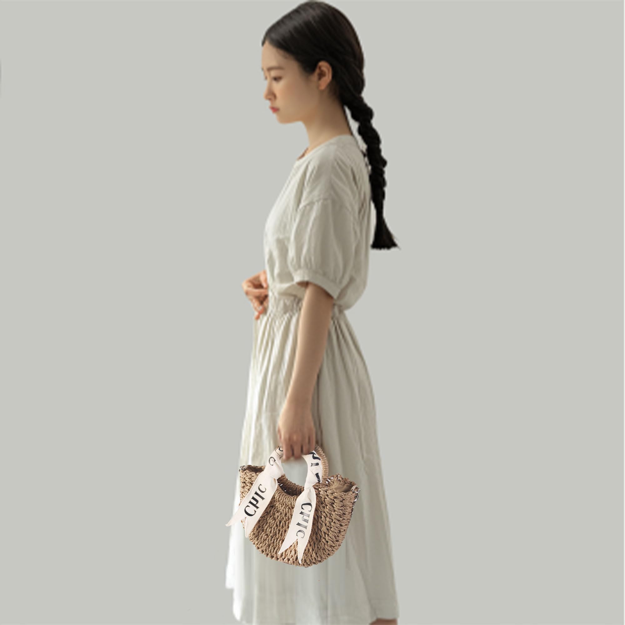Eiyye off white woven straw beach handbag with shoulder straps, perfect for summer outings and stylish beach days.