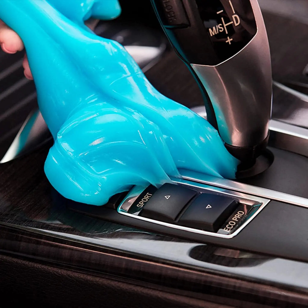 PULIDIKI car cleaning gel putty in hand, effectively removing dust from car interior surfaces and hard-to-reach areas.